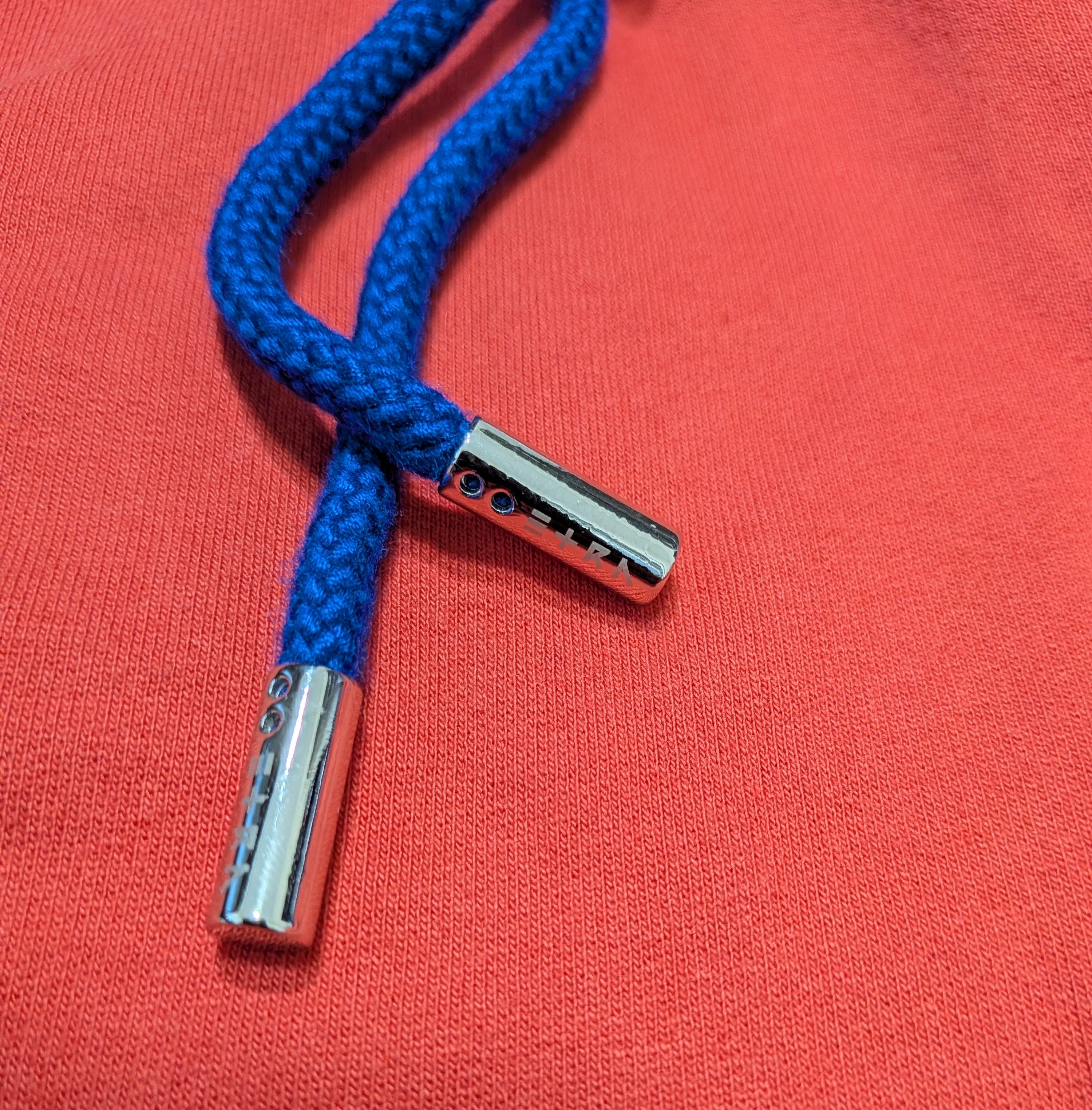 ETRN - Blue braided cord with silver metal tip.