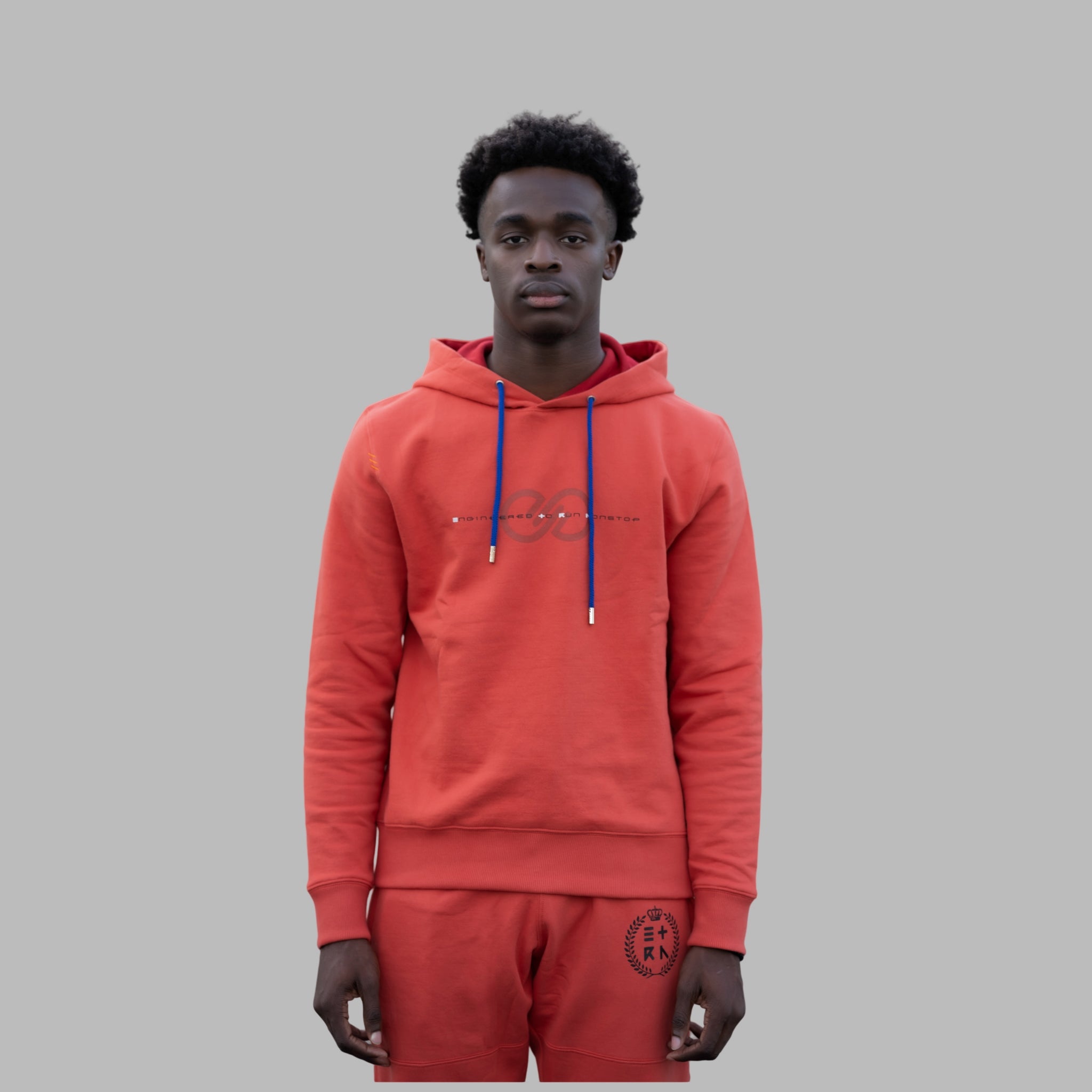 This orange Watermark Hoodie for men boasts our sleek logo, proudly displaying our slogan, "Engineered To Run Nonstop." Meticulously designed with premium soft cotton and our iconic three bar tacks on the right shoulder.