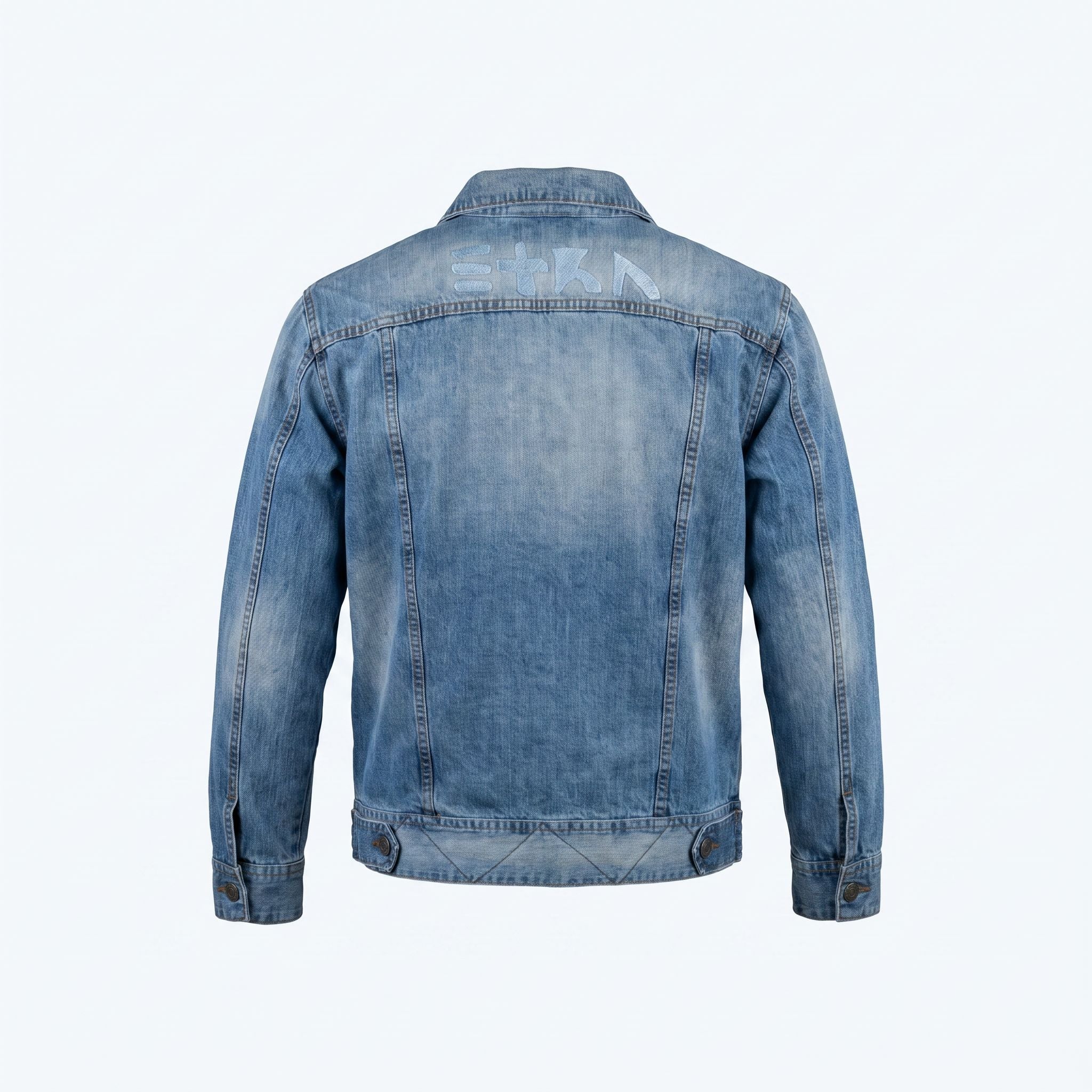 Back view of the unconventionally constructed ETRN denim jacket, demonstrating the structured streetwear fit and engineered tailoring for men. Features the brand name 'ETRN' printed across the upper back.