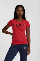 Woman wearing a red ETRN Original t-shirt with branding and navy pants