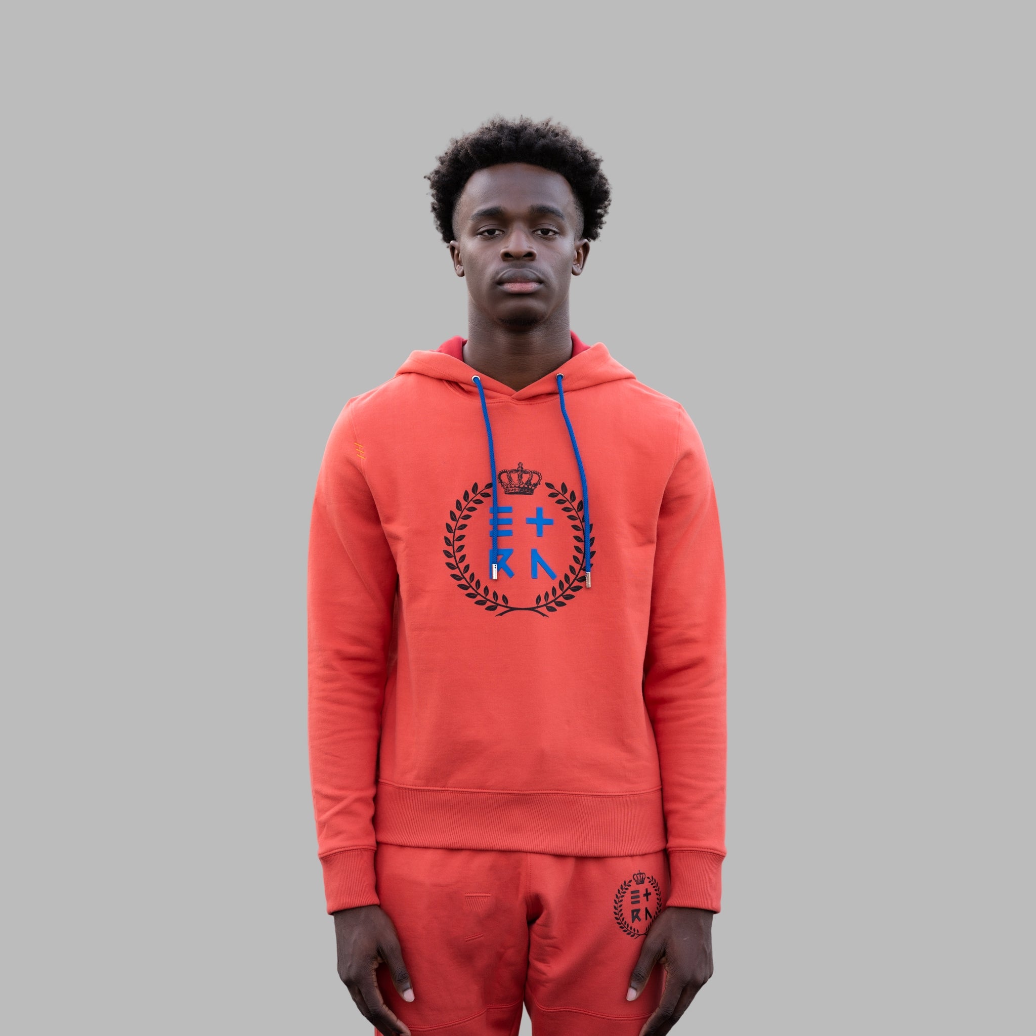 This ETRN crafted men's orange hoodie is created with luxurious and breathable cotton, the design and fabric seamlessly complement each other.